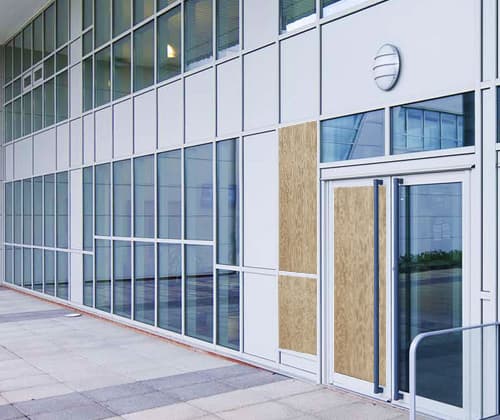 Commercial building with emergency board-up on glass doors and windows