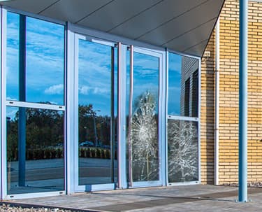 Damaged commercial storefront glass needing repair